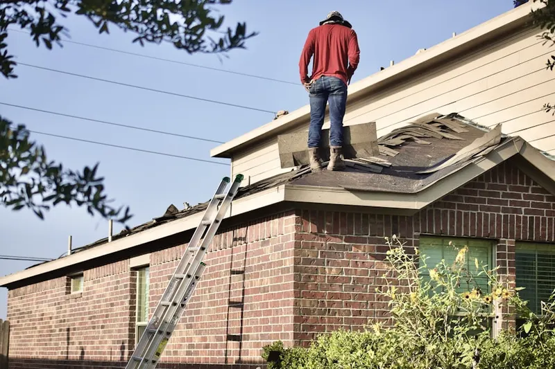 Professional roofer working on a residential roof in North Falmouth